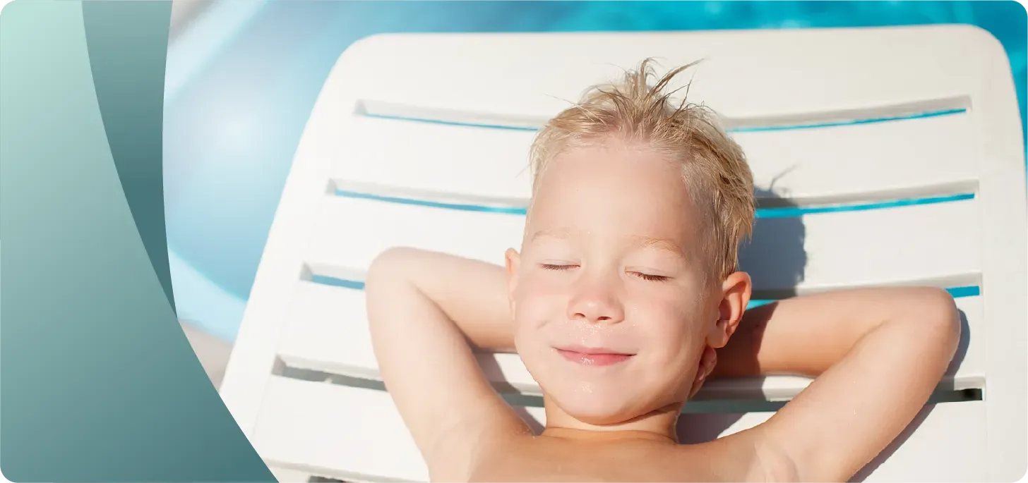 Image of a happy camp kid napping in a beach chair.