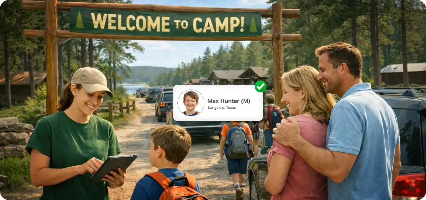Camp staff member checking in a young camper being dropped off by their parents.