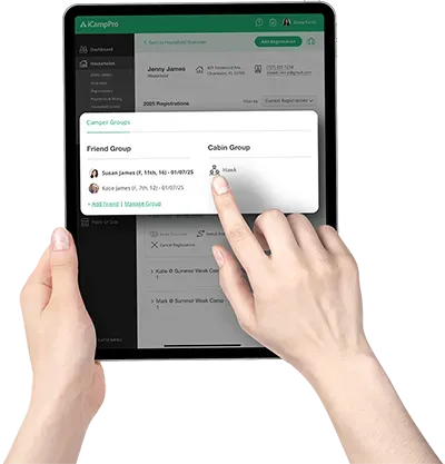 A person is holding a tablet with their finger on the screen.