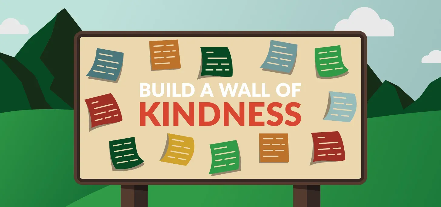A sign that says build a wall of kindness on it
