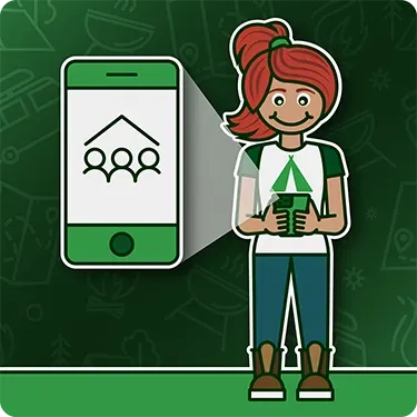 A girl is holding a cell phone in front of a cell phone with a group of people on it.