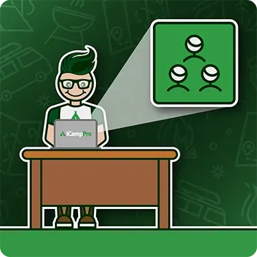 A man is sitting at a desk using a laptop computer.