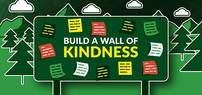 A sign that says build a wall of kindness on it