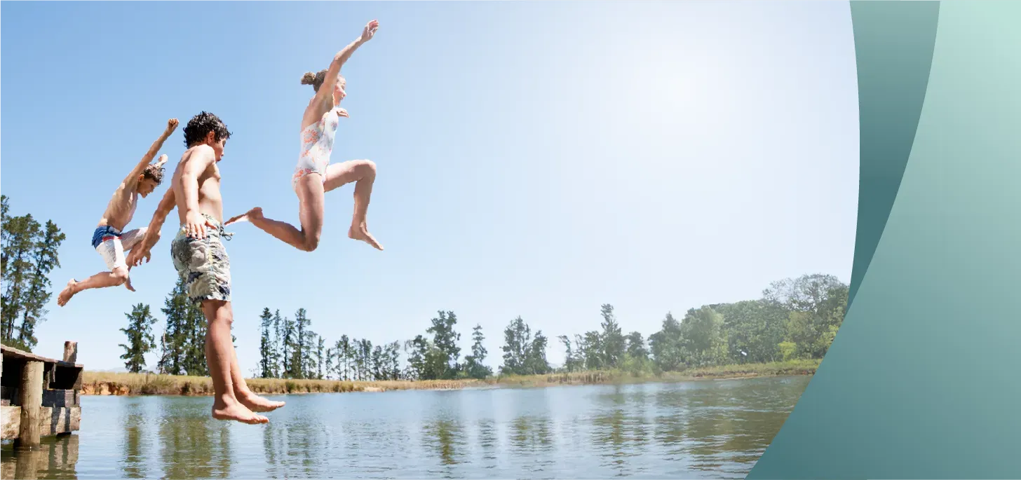 Kids jumping into the water at camp. Text: Camp Water Safety