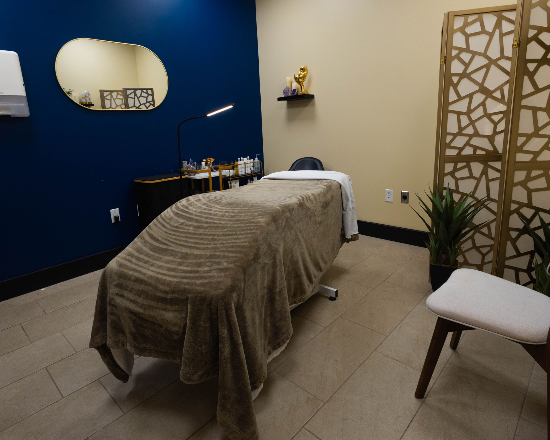 There is a massage table in the middle of the room.