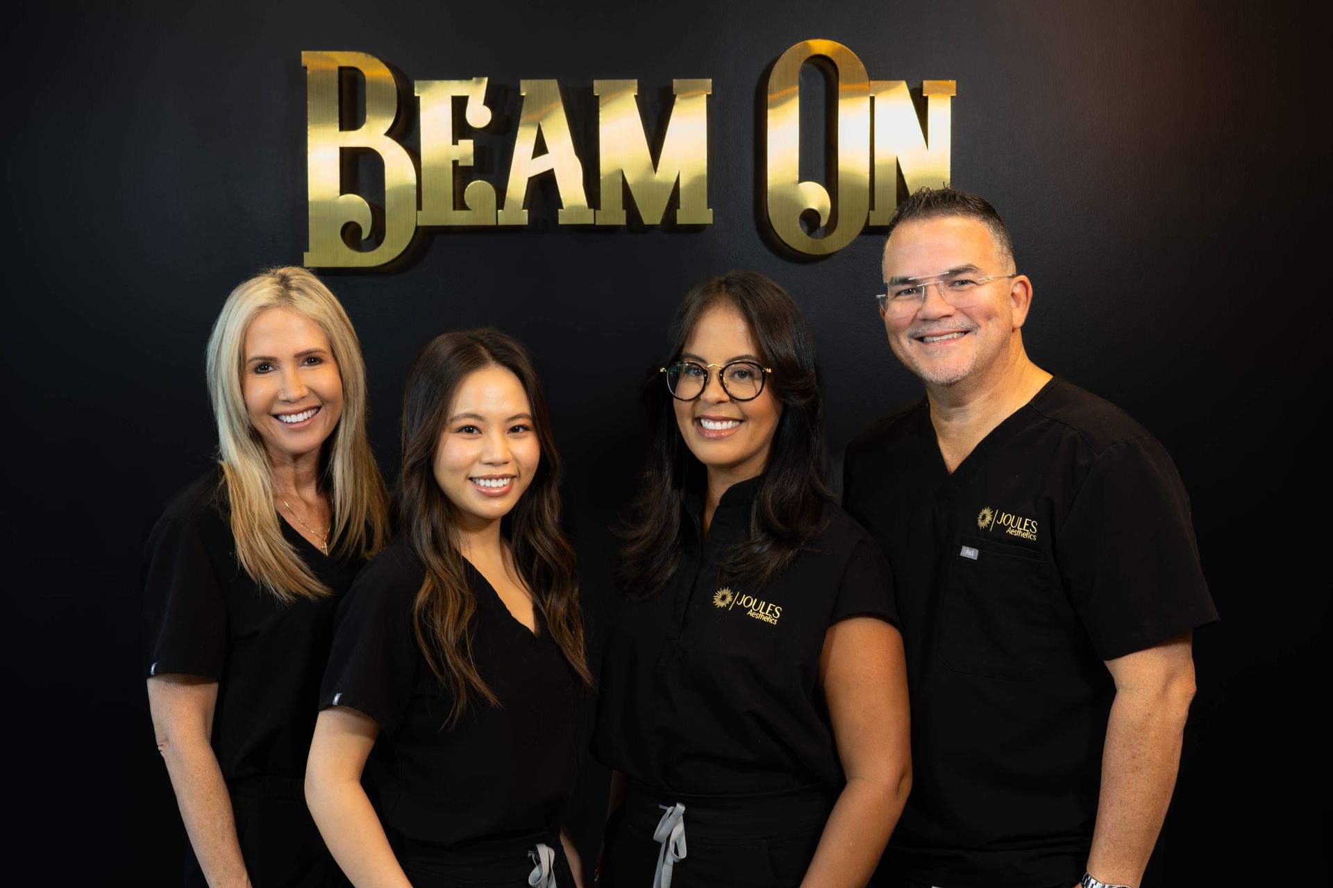 A group of people standing in front of a sign that says beam on