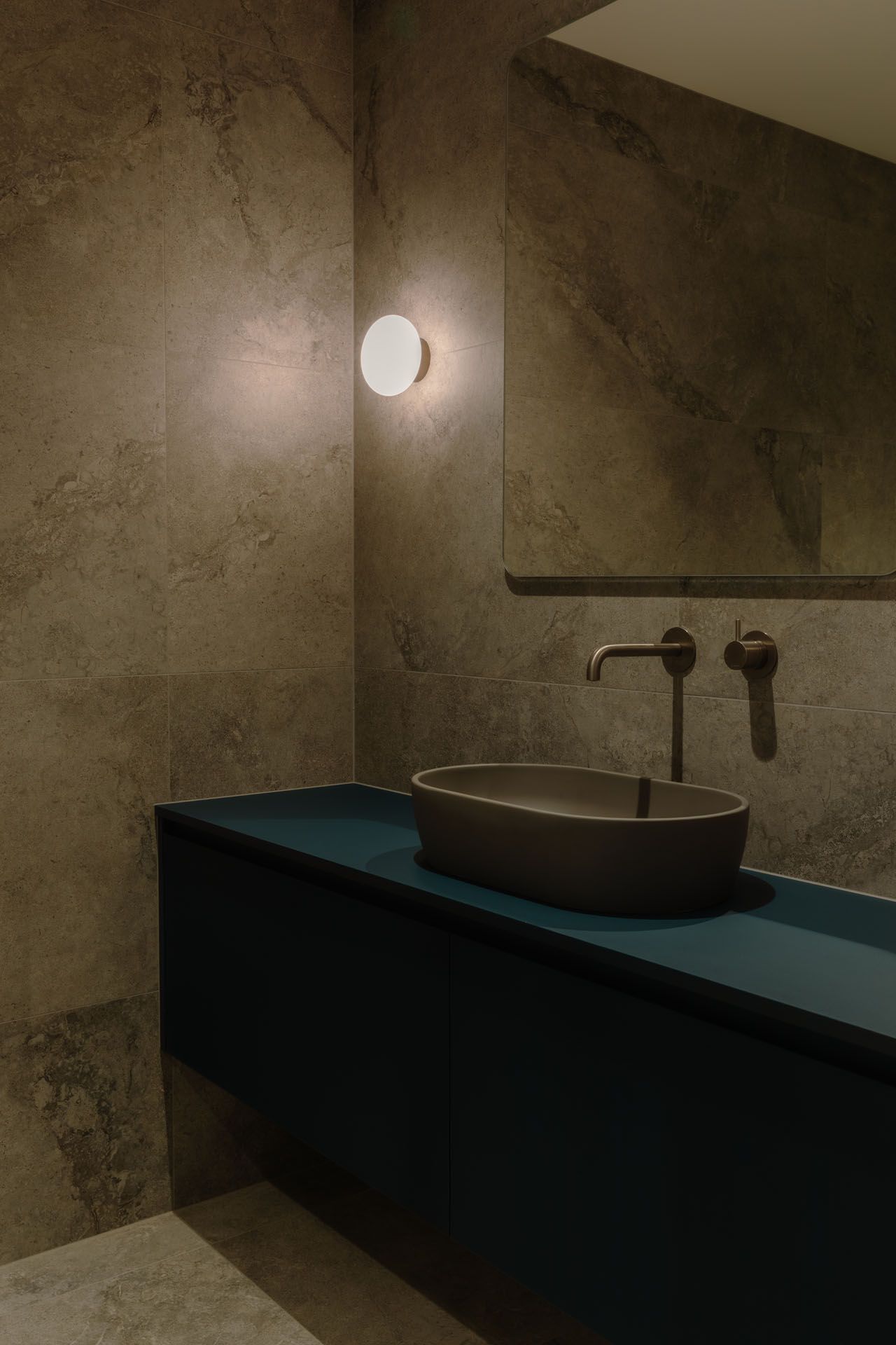 A man is standing on a ladder in a room under construction.