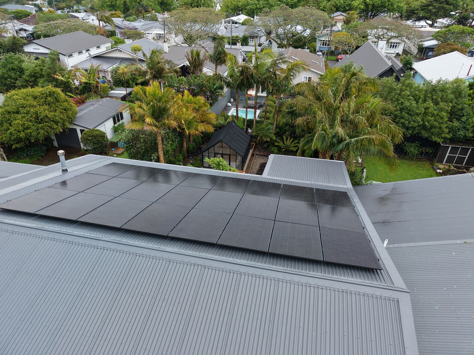 A man is installing solar panels on a roof.