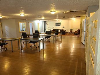 A large room with tables and chairs in it.