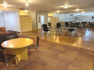 A large room with tables and chairs in it.