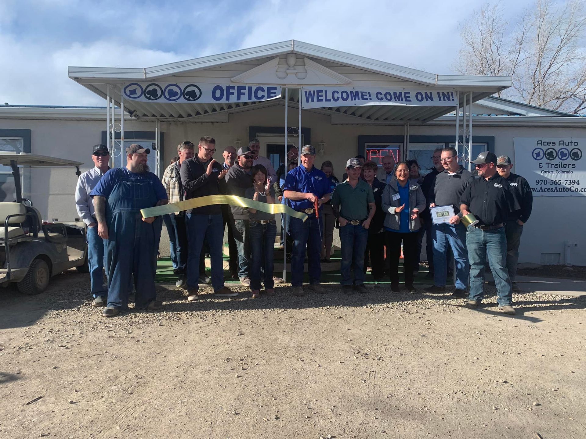 A man is sitting at a desk in front of a laptop computer.