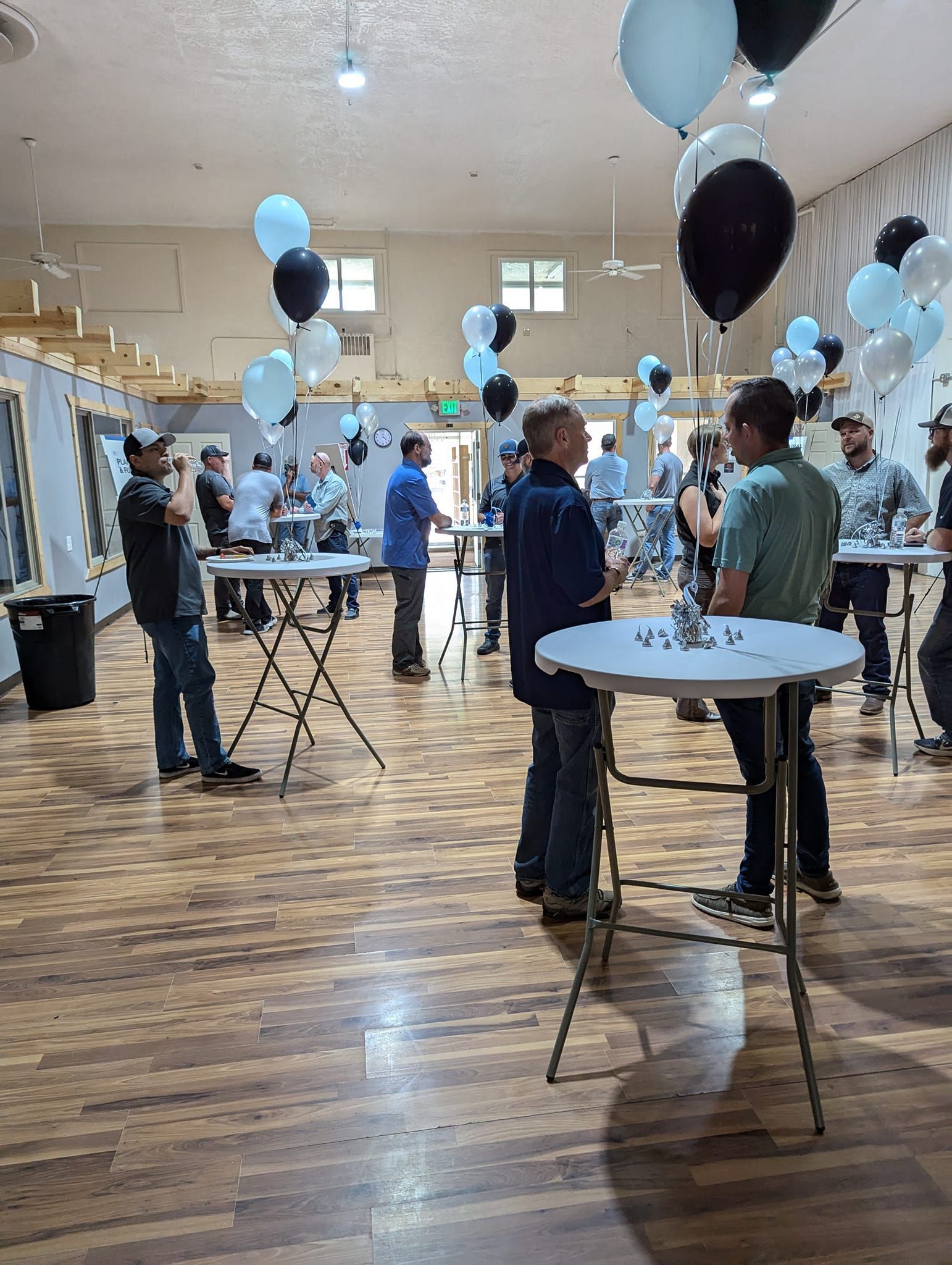 A man in a suit and tie is sitting at a desk with a laptop.