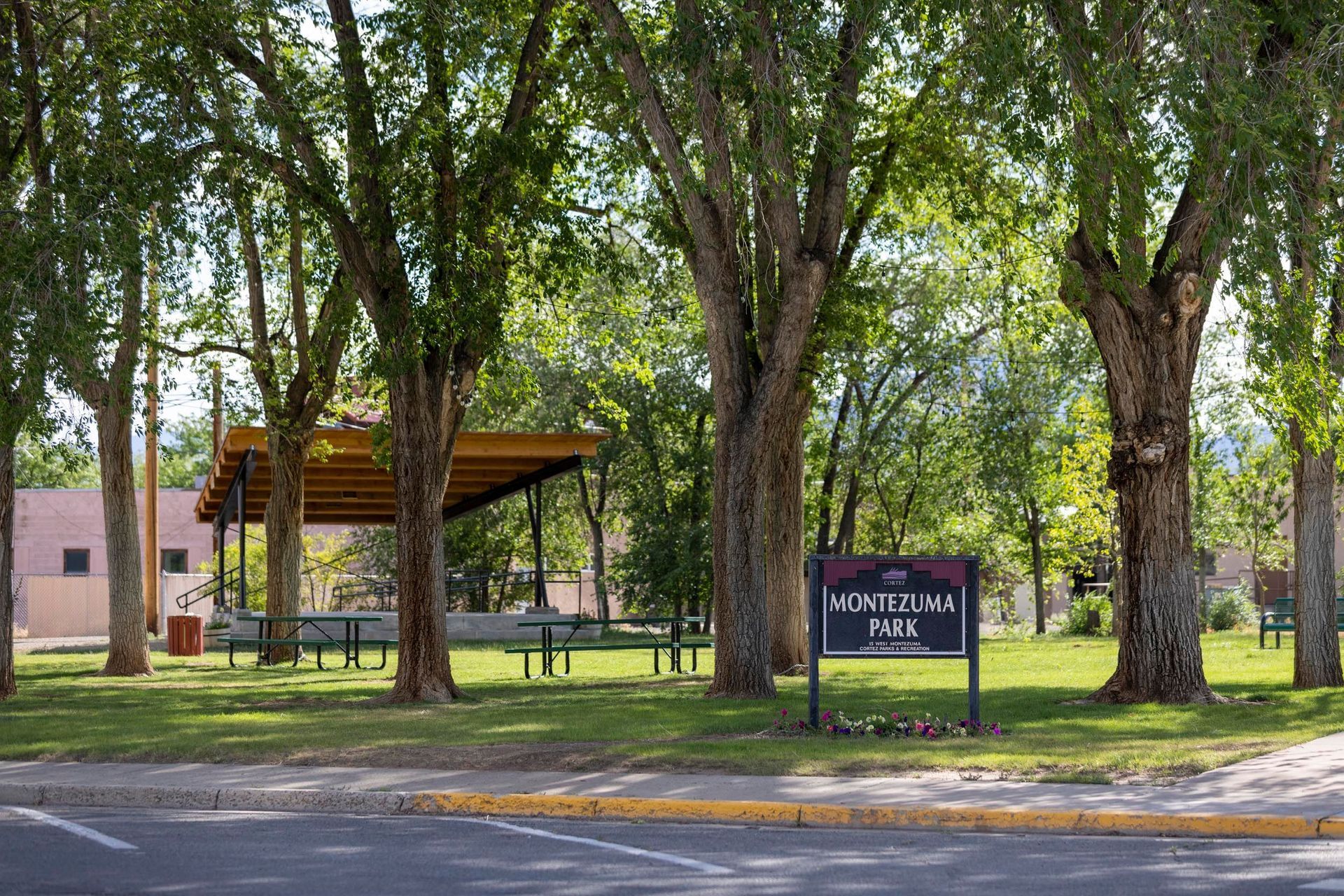 A park with trees and a sign that says ' morgan 's park ' on it
