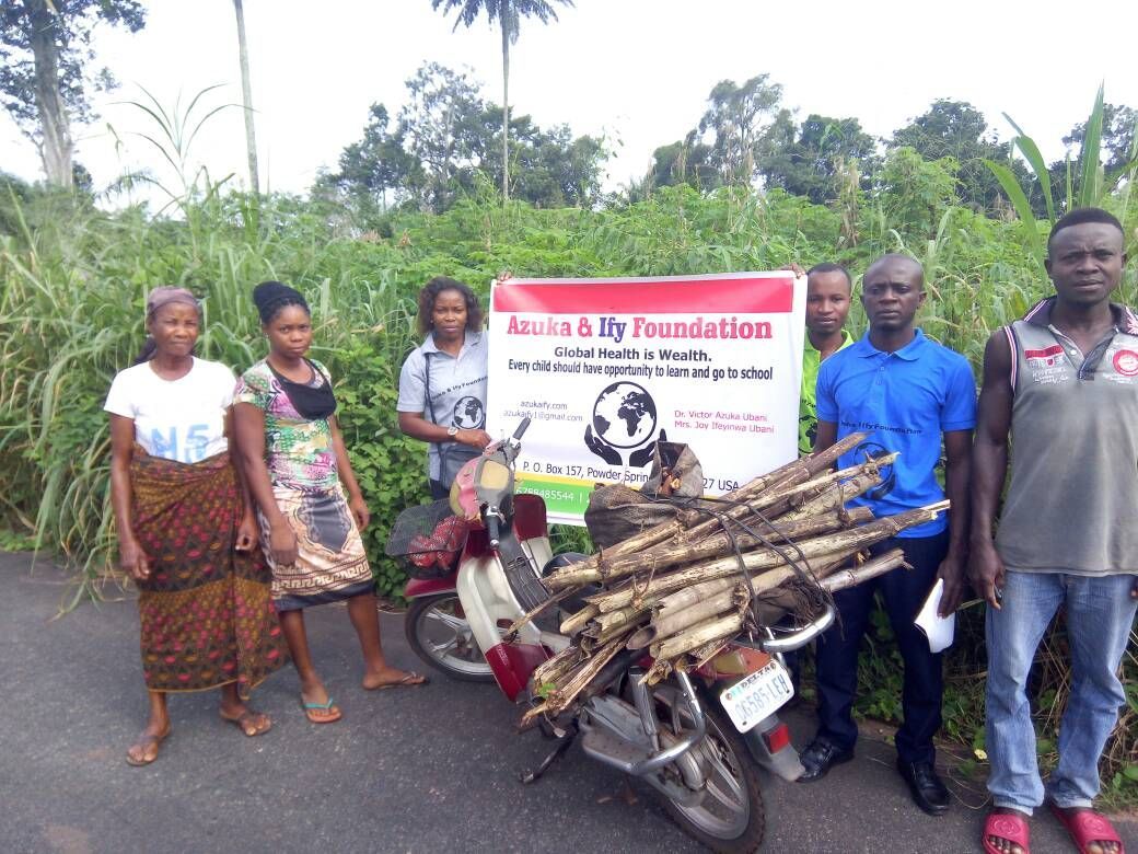 A group of people standing next to a motorcycle with a sign that says ' africa b lift foundation ' on it