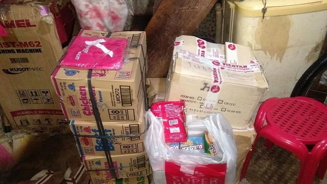 A bunch of boxes are stacked on top of each other in a room.