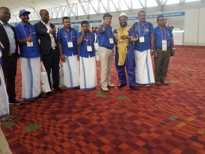 A group of men are posing for a picture on a red carpet