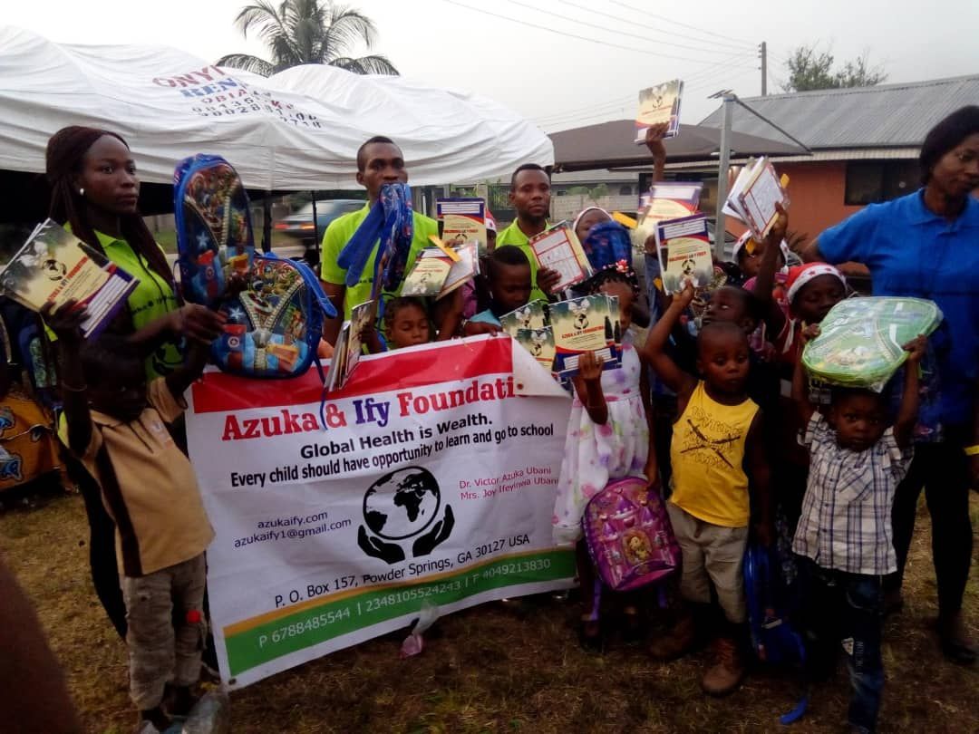 A group of people holding a sign that says azuka by foundation