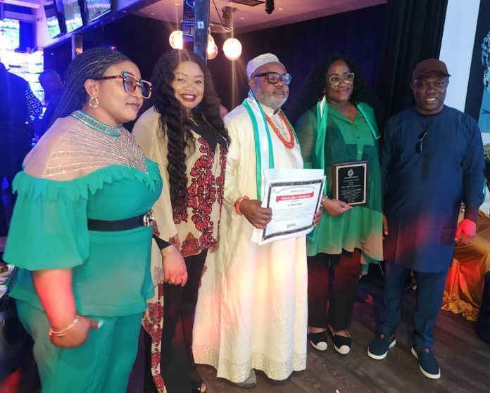 A group of people standing next to each other holding a certificate.