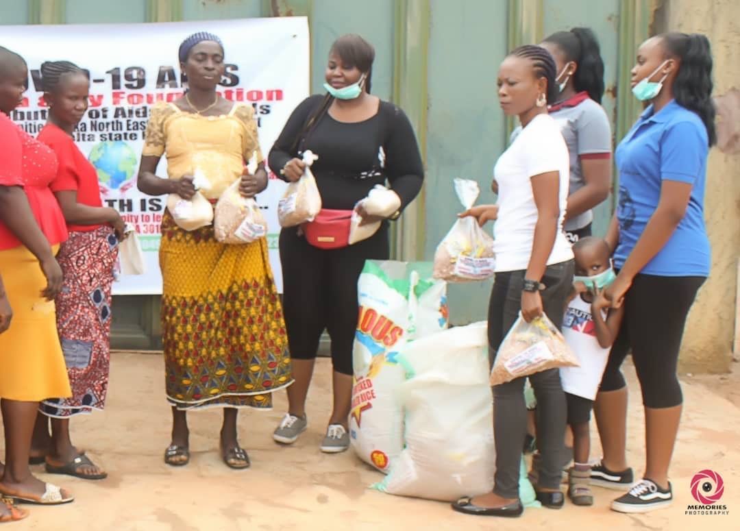 A group of women standing in front of a sign that says -19