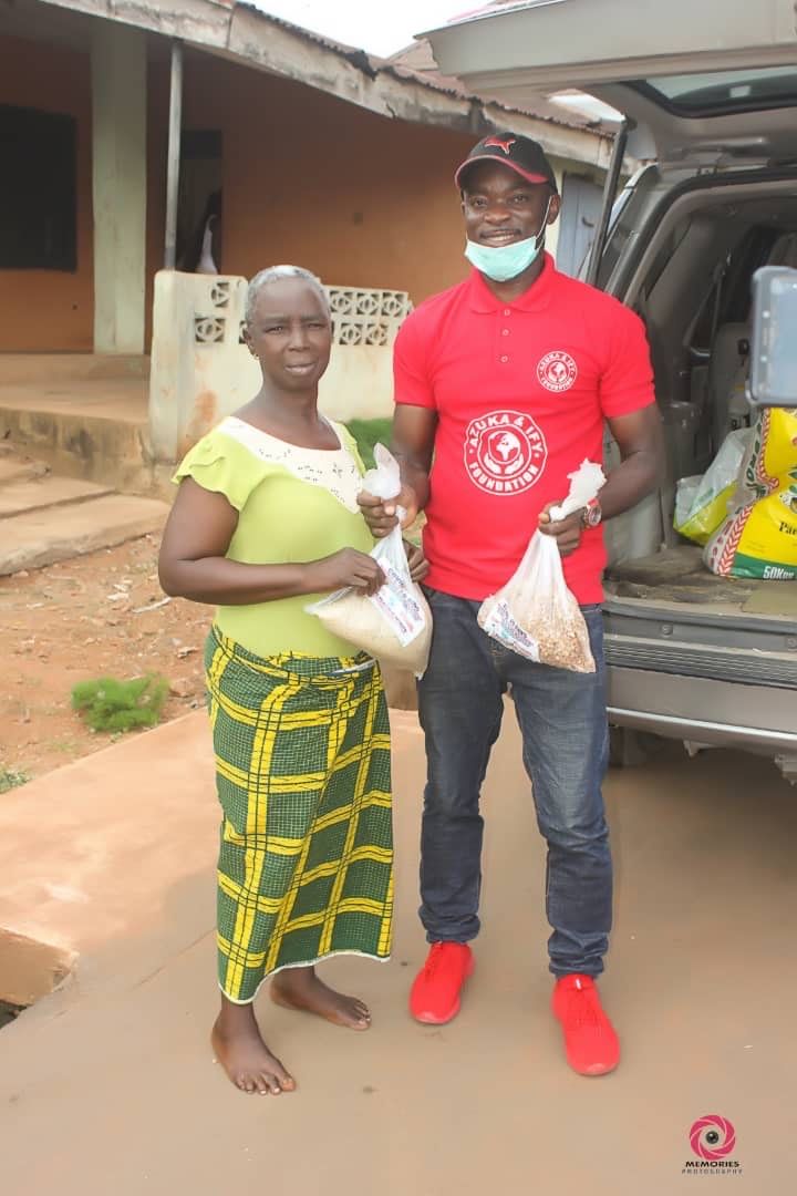 A man and a woman are standing next to each other in front of a car.