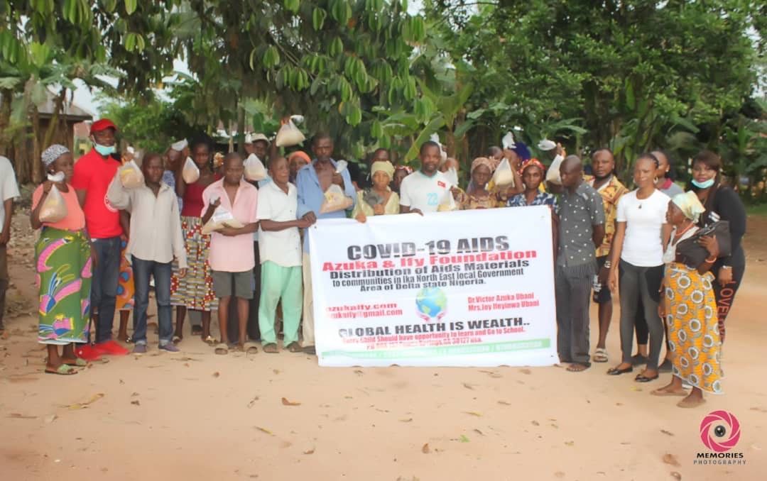 A group of people are standing in front of a sign.