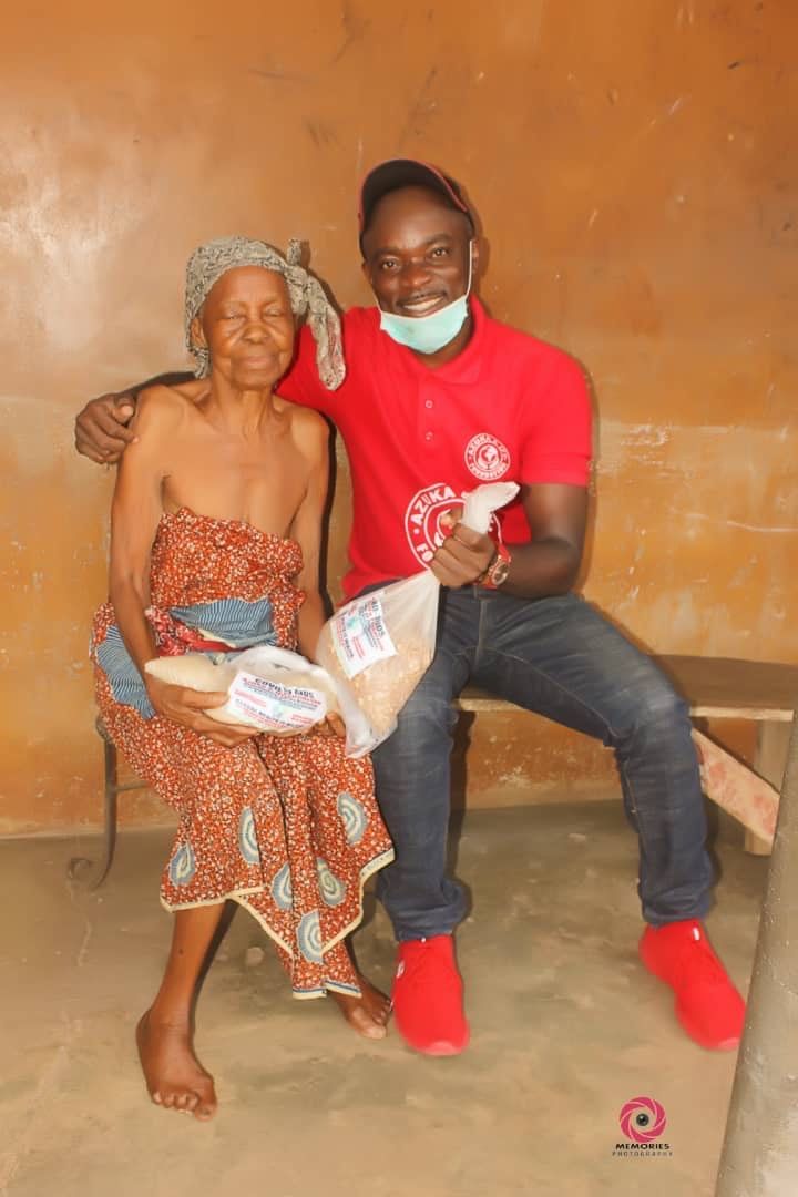 A man in a red shirt is sitting next to an older woman