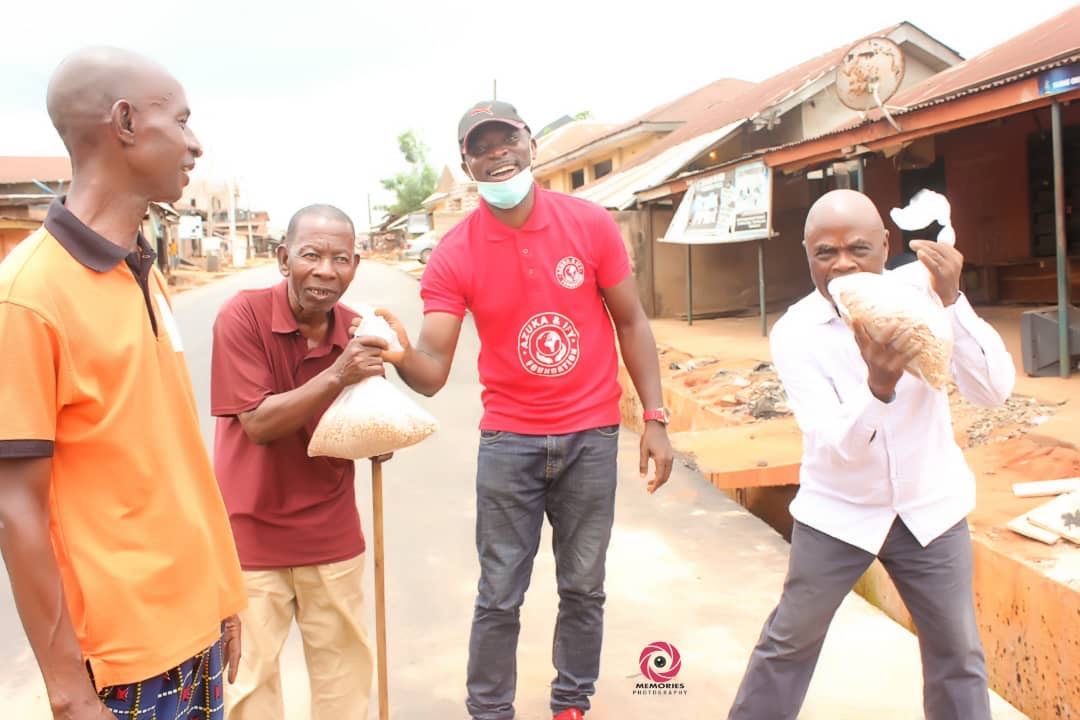 A group of men are standing next to each other on a street.