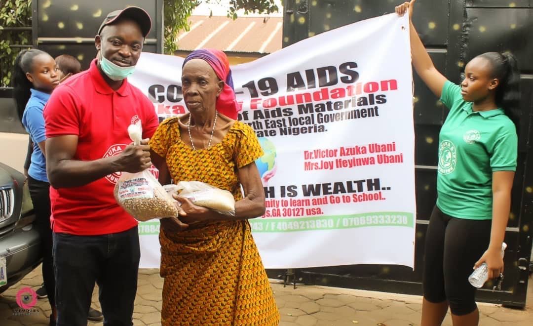 A group of people are standing in front of a sign that says 19 aids foundation