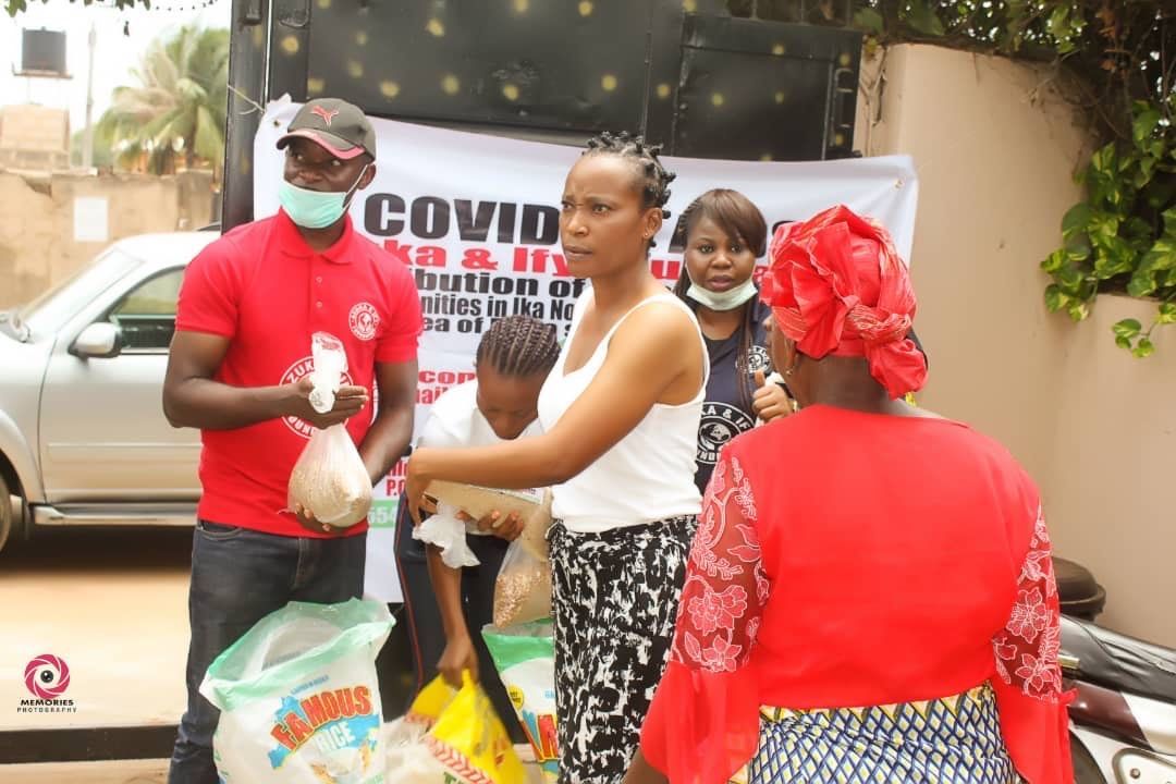 A group of people are standing in front of a sign that says covid.