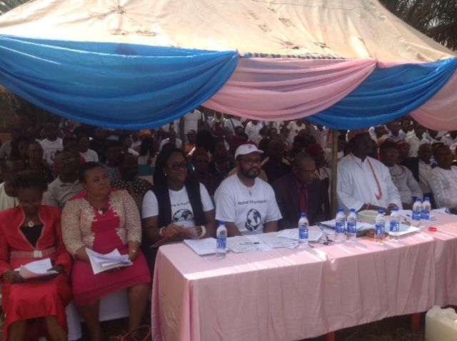 A group of people sitting at a table under a tent