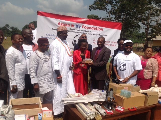 A group of people standing in front of a sign that says azura & ifly foundation