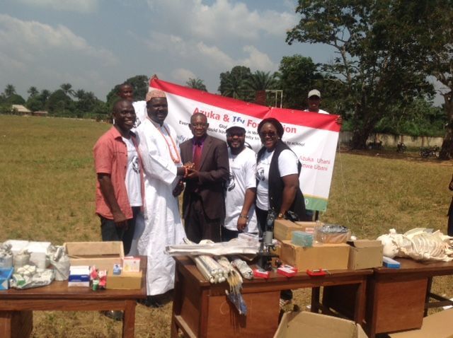 A group of people standing in a field holding a flag that says ' a & p ' on it
