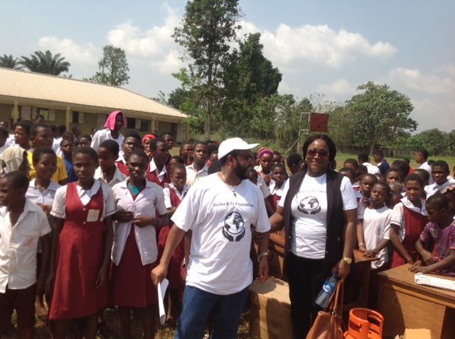 A group of people are standing in front of a building
