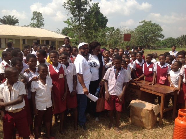 A group of children are posing for a picture in a field