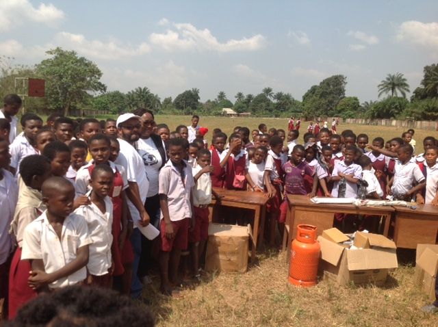 A group of children are posing for a picture in a field