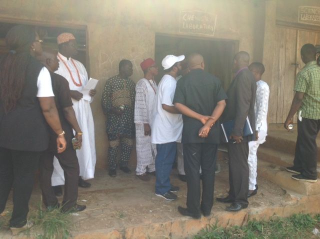 A group of people are standing in front of a building that has the word church on it
