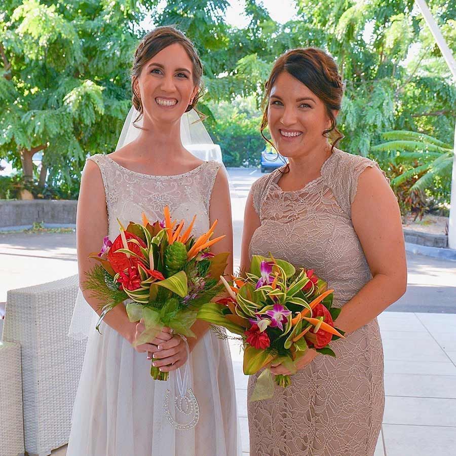 Two Women Standing Next to Each Other Holding Bouquets of Flowers — Castletown Flower Hut in Pimlico, QLD