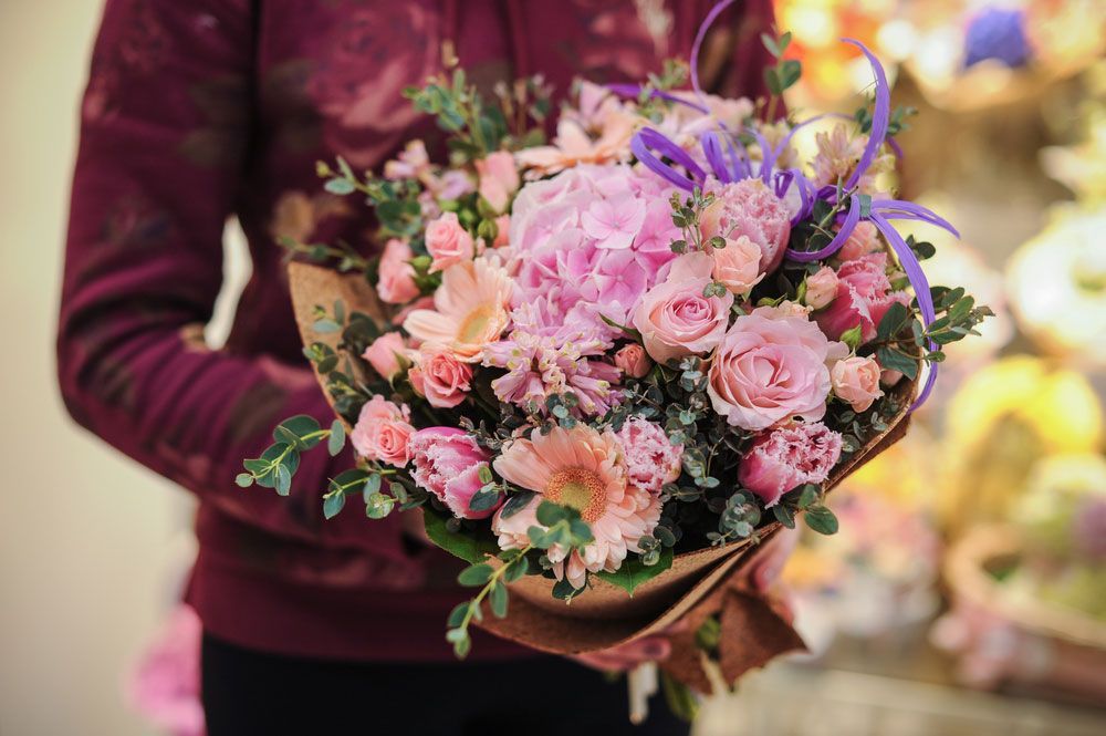 A Woman is Holding a Bouquet of Pink Flowers in Her Hands — Castletown Flower Hut in Pimlico, QLD