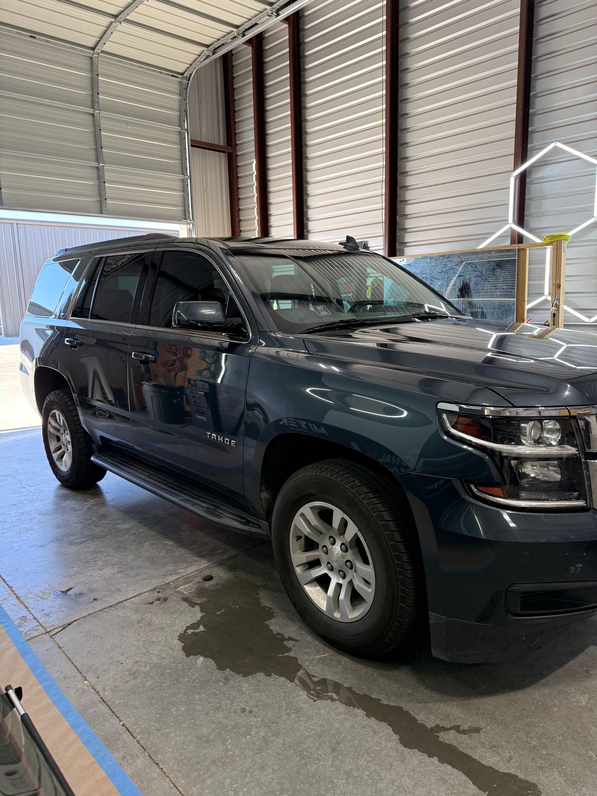 Dark blue SUV parked in a garage.