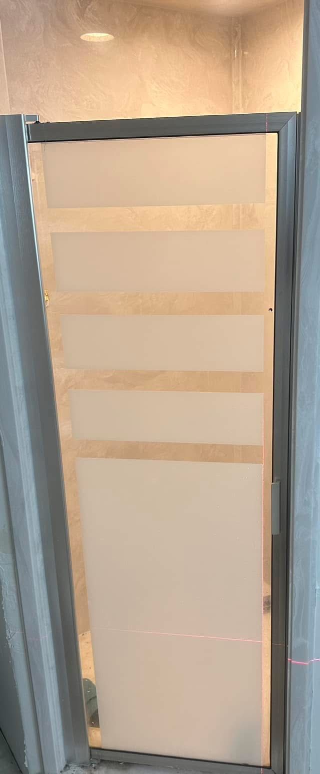 A white door, held together with horizontal tan tape strips, set in a metal frame.