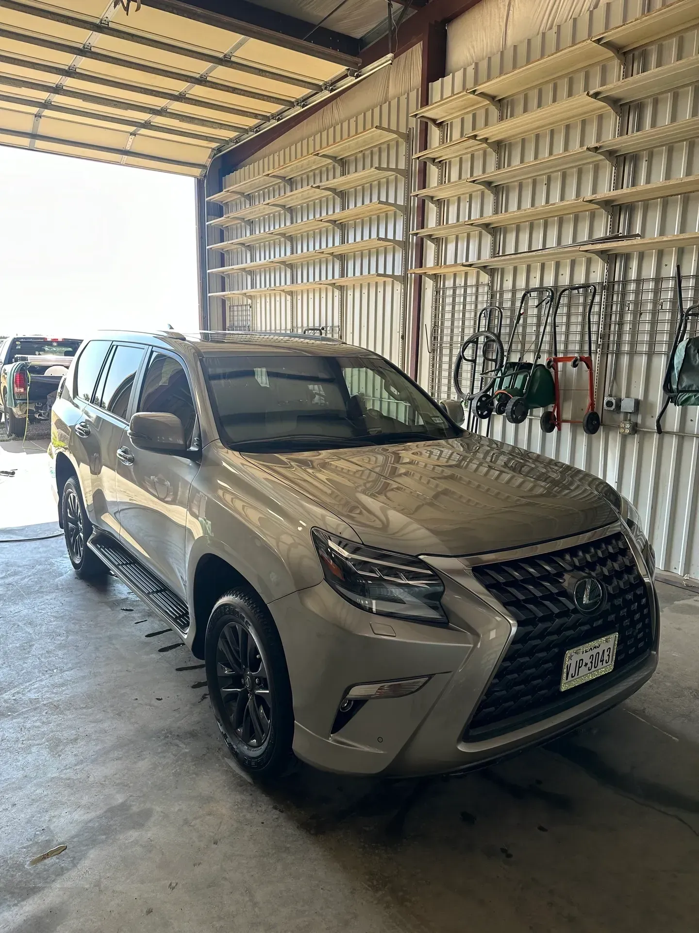 Tan Lexus SUV parked inside a garage.