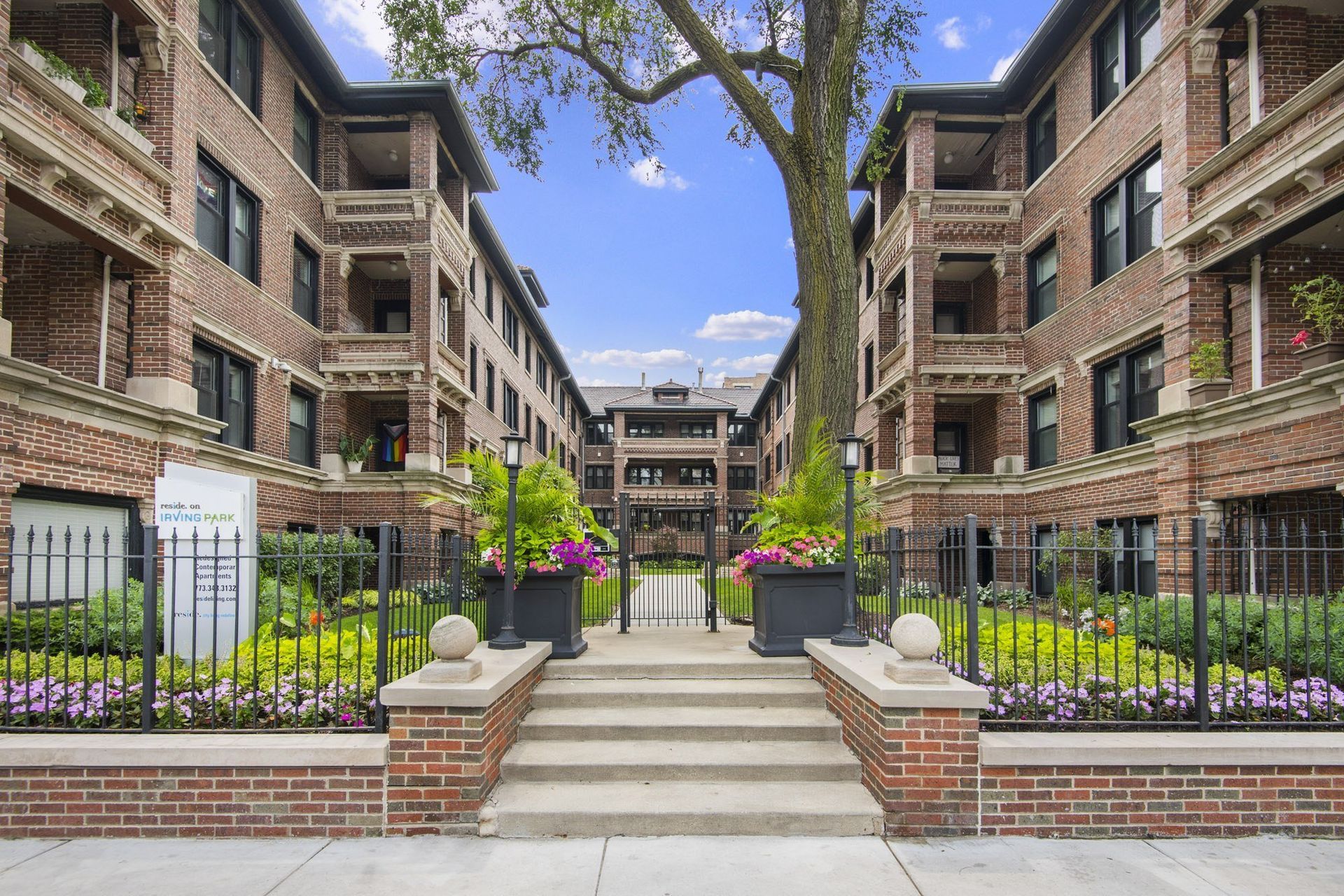 the view of a courtyard between two apartment buildings