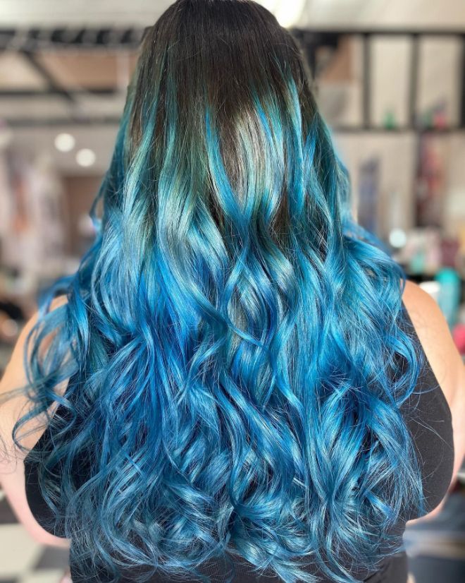 A Woman with Long Blue Hair Is Wearing a Black Tank Top — Ammo Hair and Beauty In Maclean, NSW