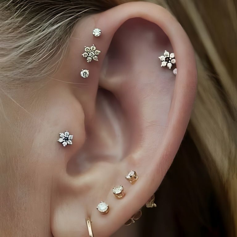 A Close up Of a Woman's Ear with Multiple Piercings — Ammo Hair and Beauty In Maclean, NSW