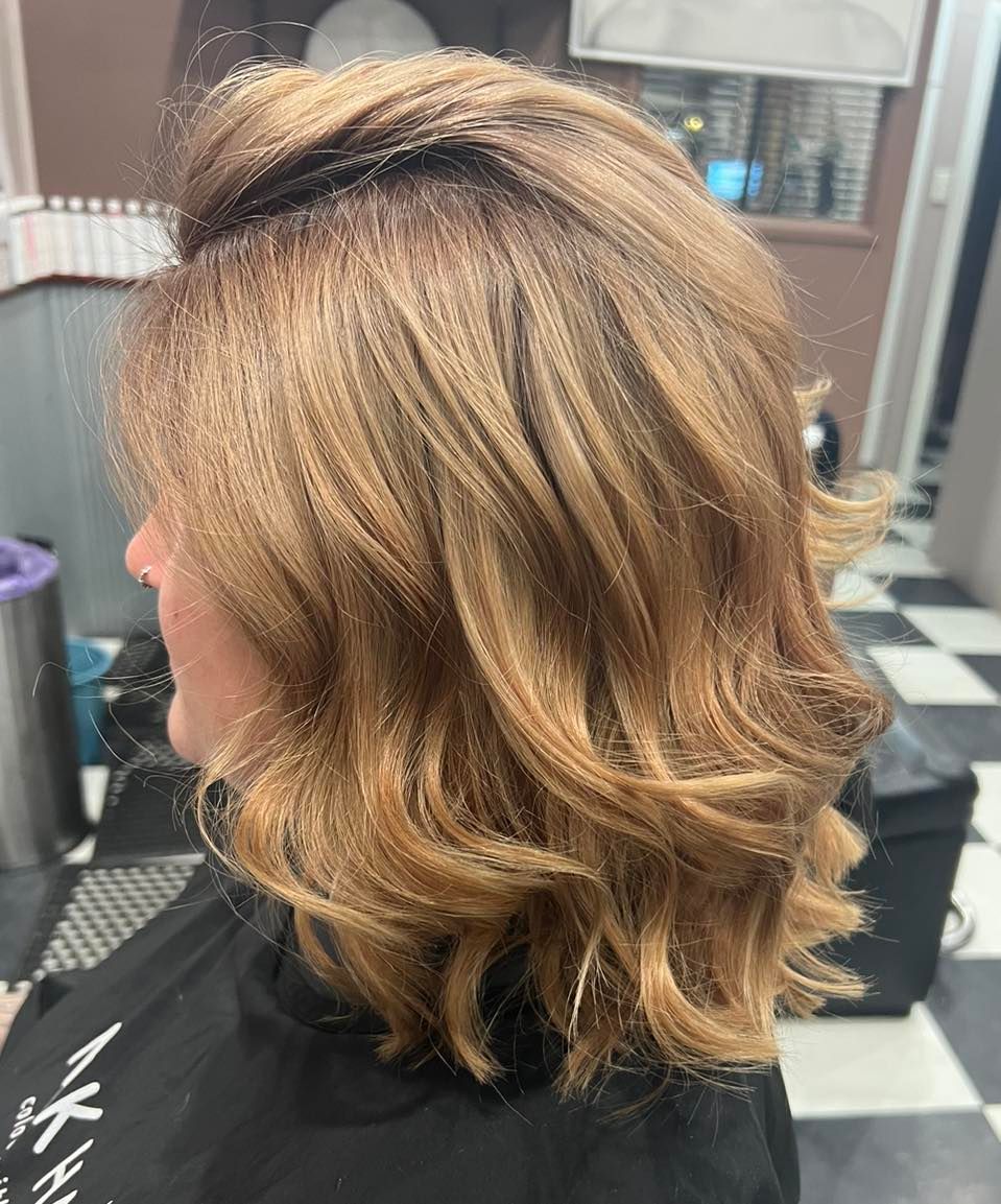 A Woman with Blonde Hair Is Sitting in A Chair in A Salon — Ammo Hair and Beauty In Maclean, NSW