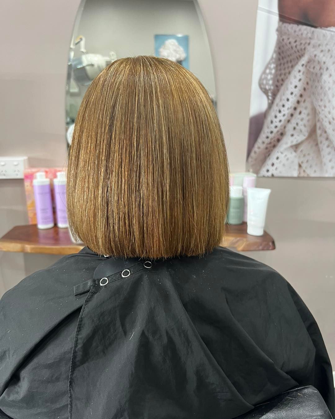 A Woman Is Getting Her Hair Cut in A Salon — Ammo Hair and Beauty In Maclean, NSW