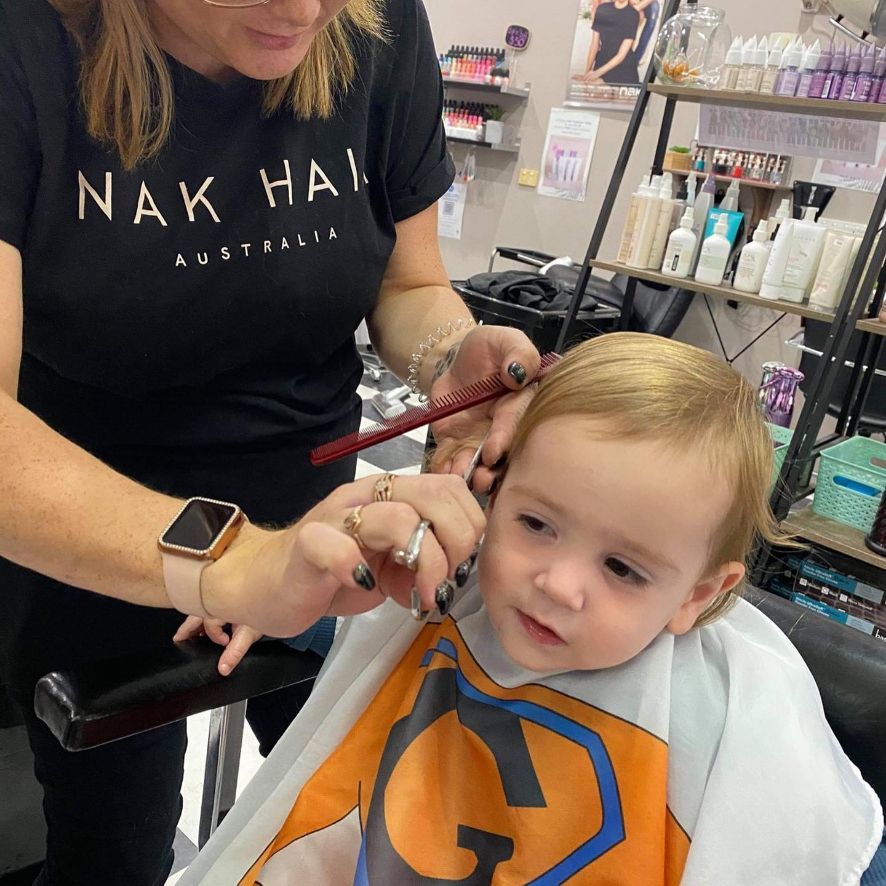 A Young Child Gets a Haircut at A Salon — Ammo Hair and Beauty In Maclean, NSW