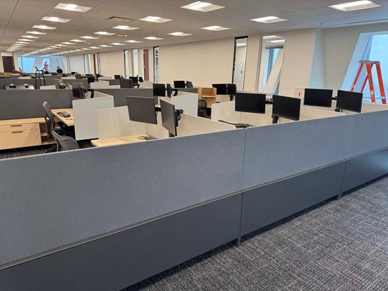 A large office with a lot of cubicles and desks