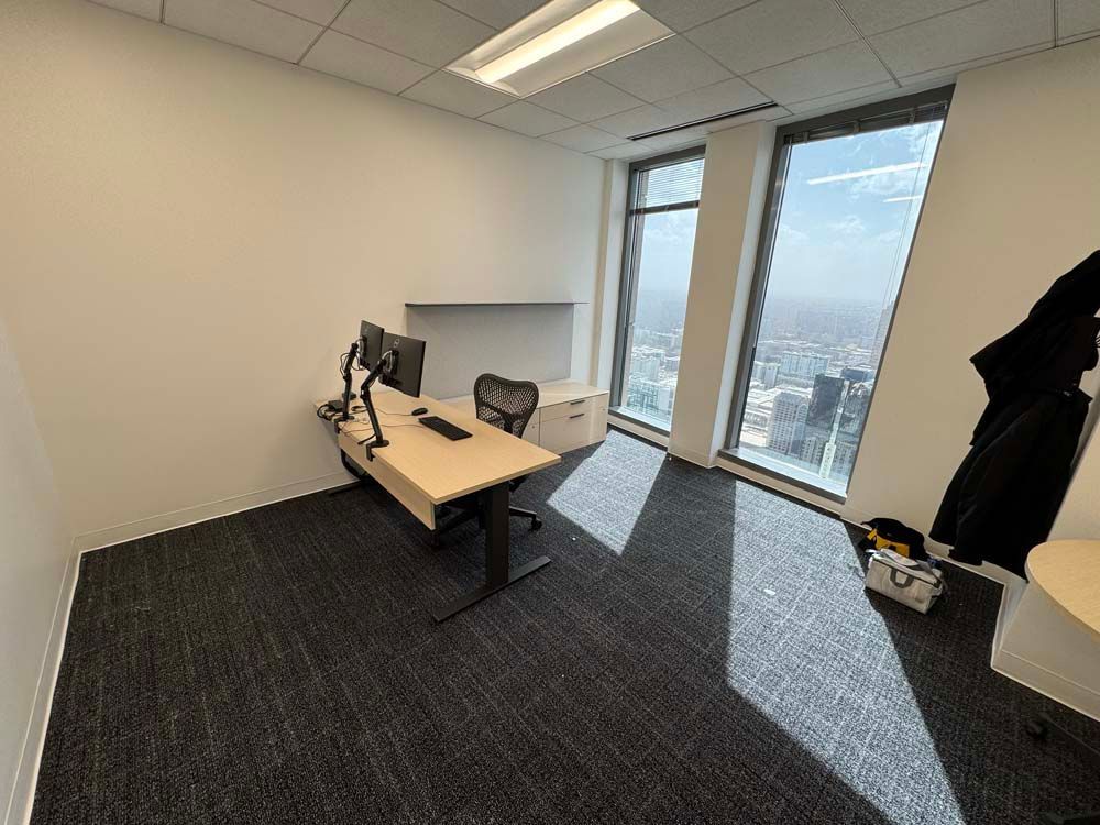 A small office with a desk , chair and computer.