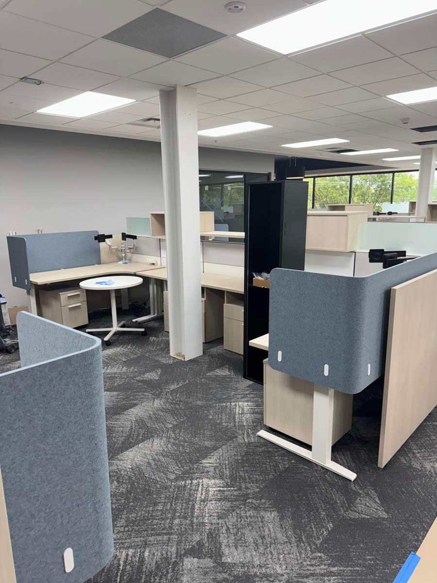 A large office with a lot of desks and cubicles.